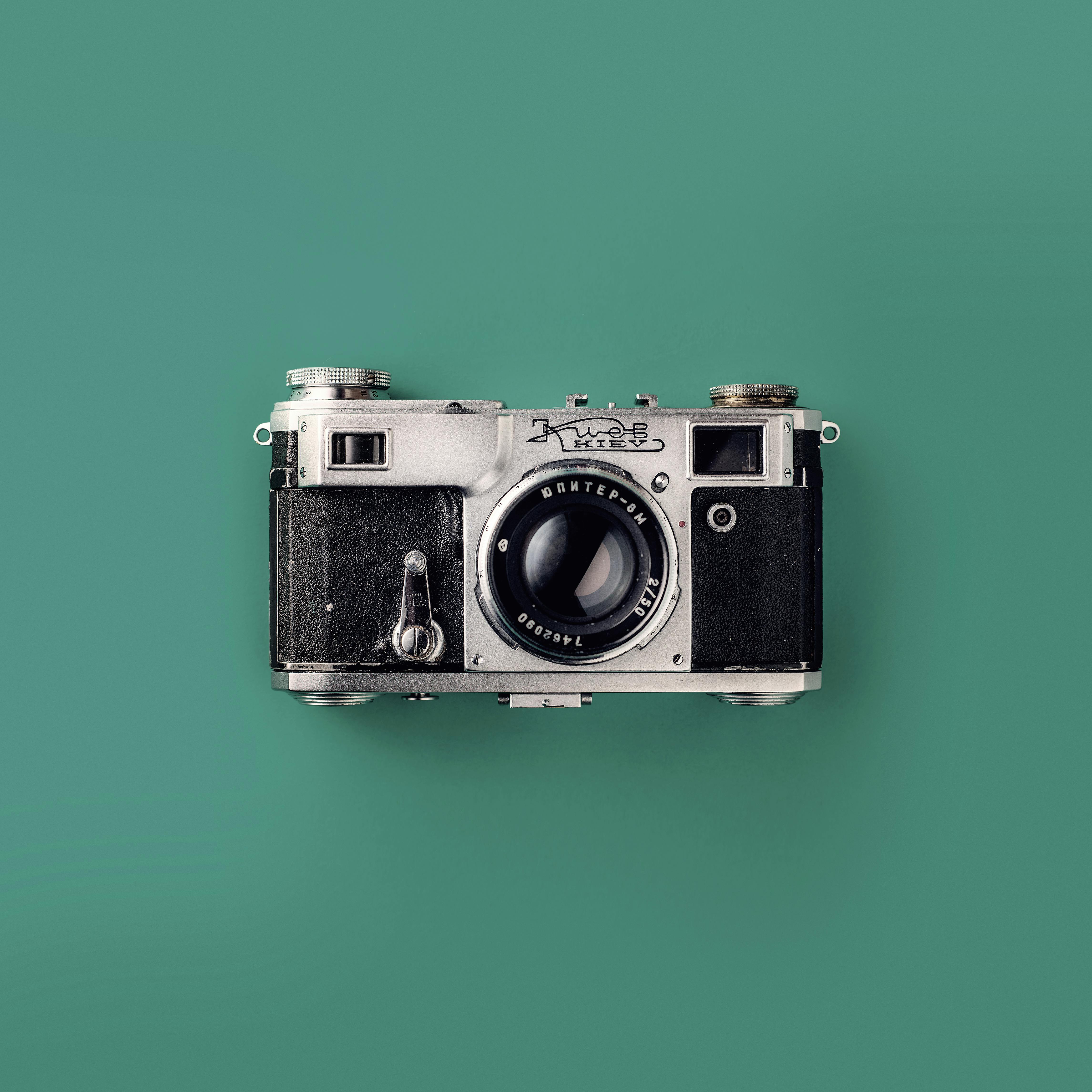 Classic vintage camera with a green background, symbolizing retro photography and nostalgia.